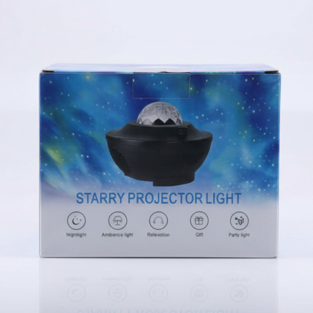 A boxed projector light product package standing upright on a light surface. The box features a blue and white galaxy-style background with an illustration of a black bowl-shaped projector.