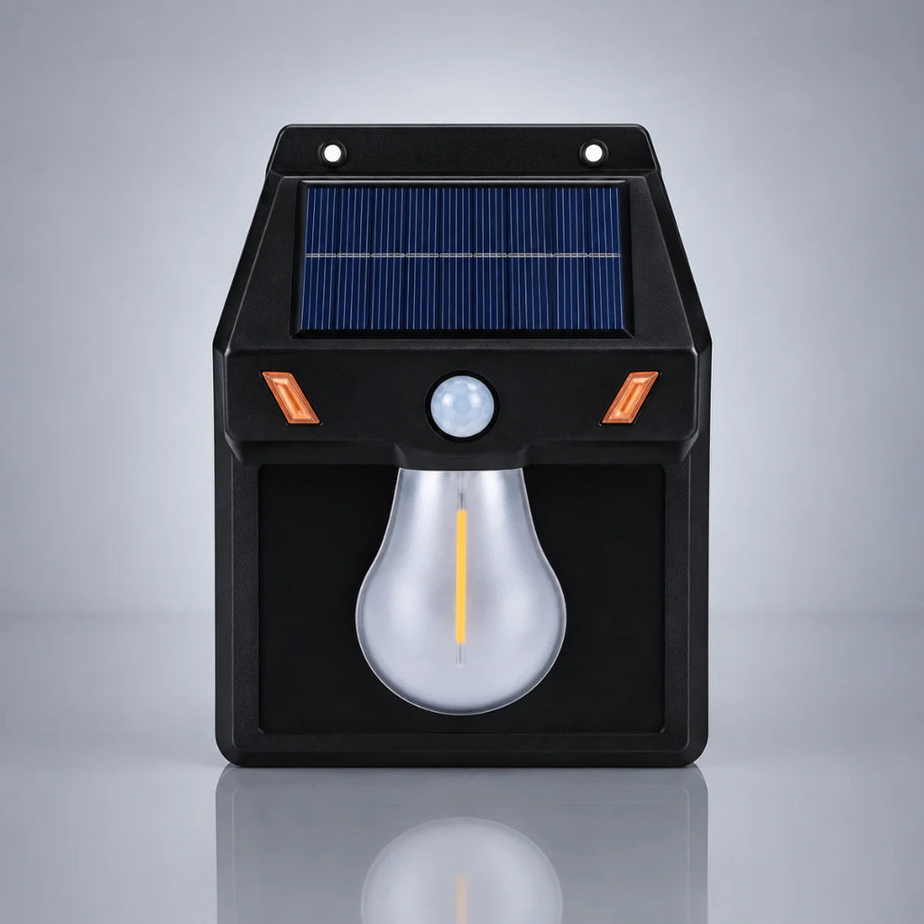 A black solar-powered outdoor security light with a blue solar panel, motion sensor, and a large bulb-shaped LED light, shown on a reflective gray background.