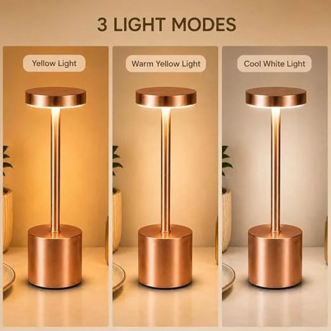 A three-panel comparison showing a slim cylindrical table lamp in three lighting modes: Yellow Light, Warm Yellow Light, and Cool White Light. The lamp has a metallic rose-gold/copper finish and is shown lit on a tabletop with a warm-toned background.