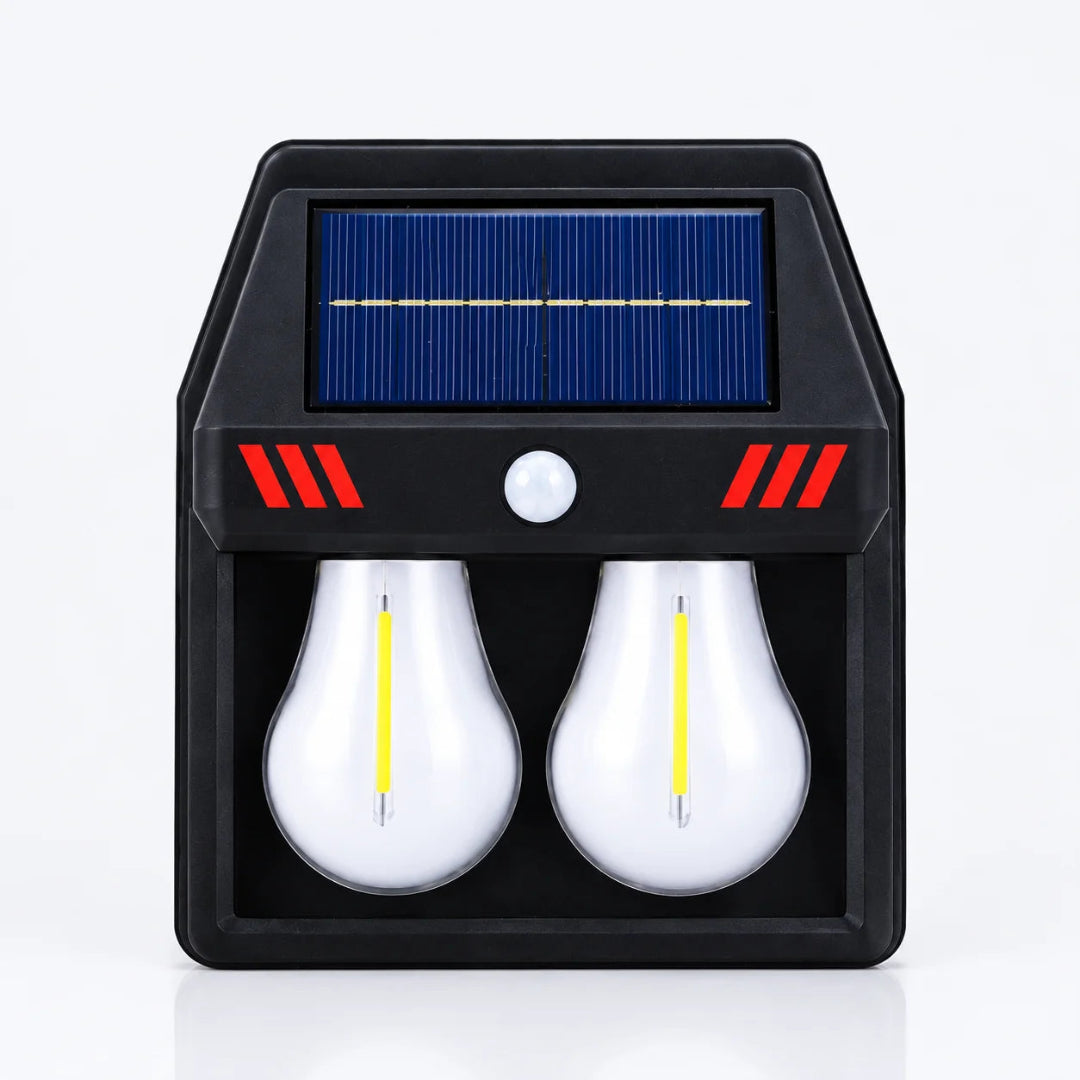 A solar-powered dual light fixture with a black housing, a blue solar panel on top, red accent stripes, and two white LED light bulbs inside.