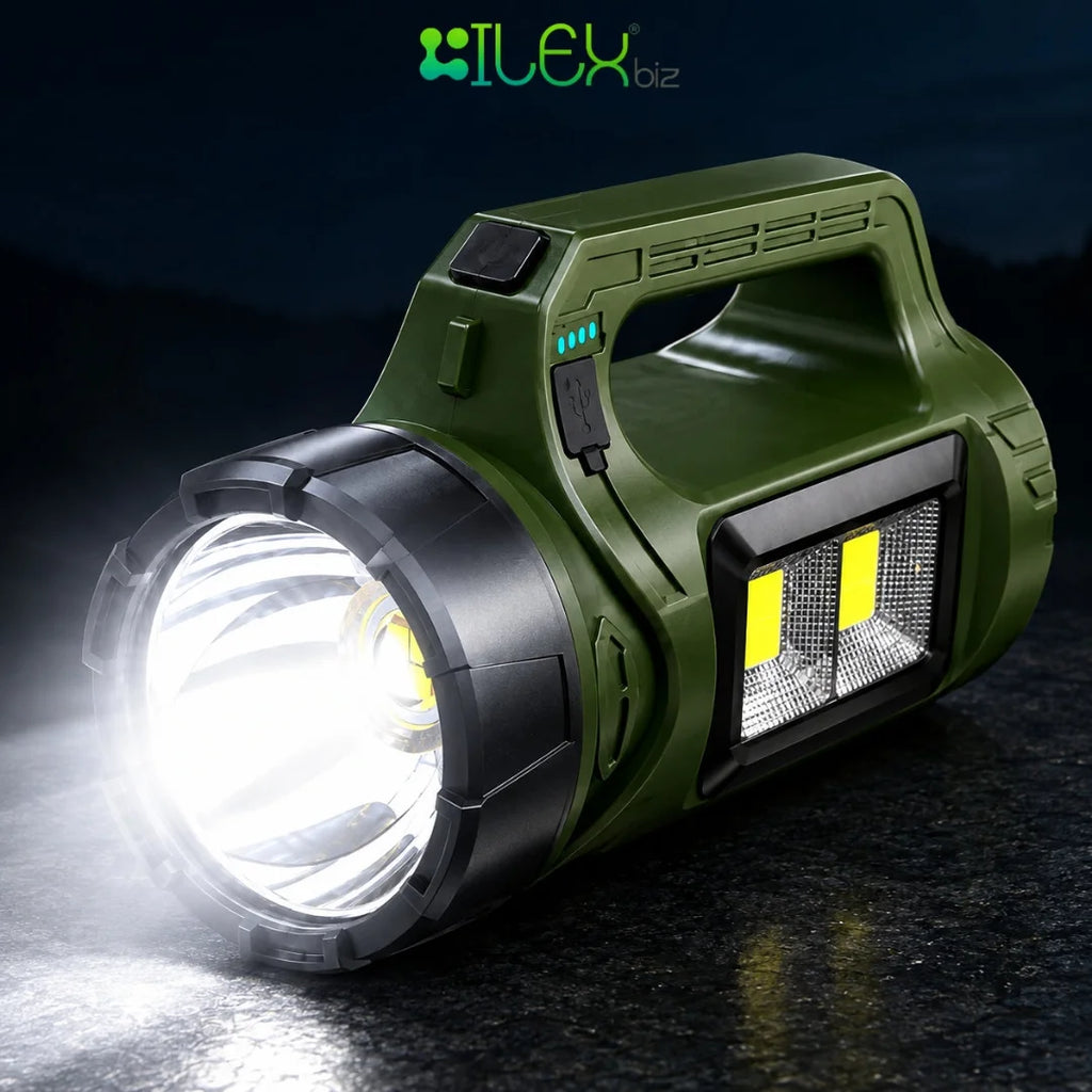 An Ilex biz portable LED flashlight in olive green and black, shown with its main beam turned on and emitting a bright white light. The flashlight features a built-in handle, a side power bank port, and a front LED light panel, set against a dark, reflective background.
