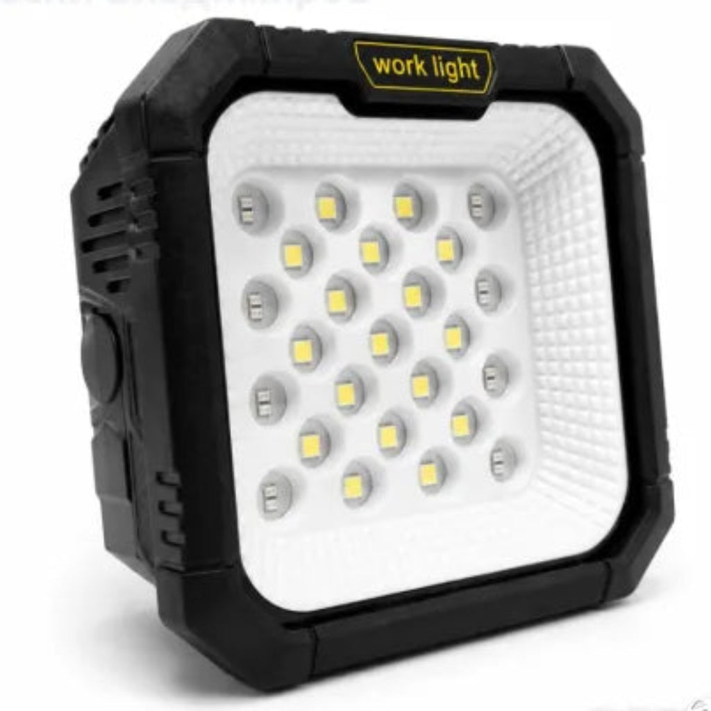 A rugged square work light with a black protective casing, a white textured front panel, and multiple LED chips, shown on a clean white background. A yellow label on the top edge reads 'work light'.