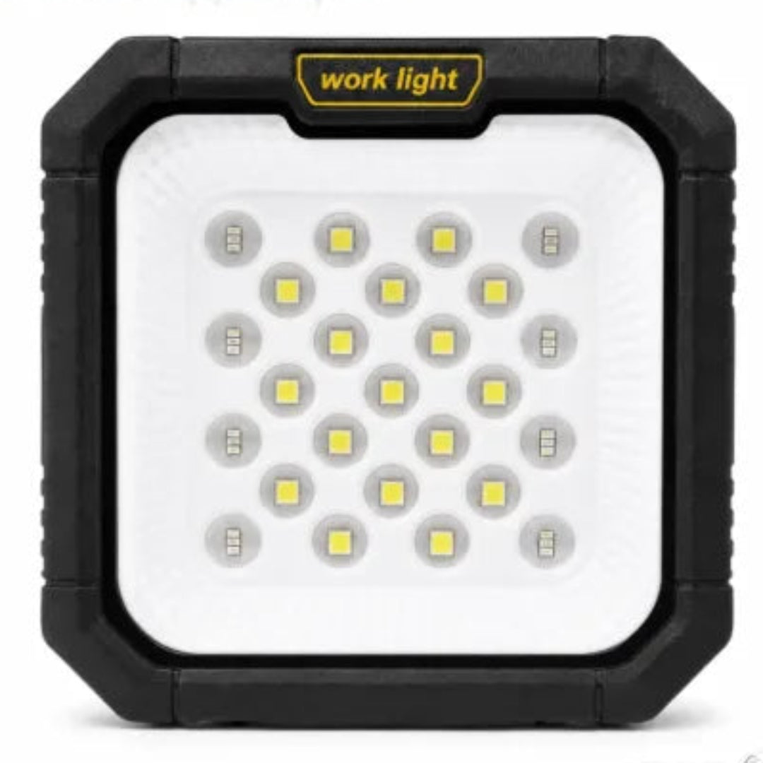 A square portable LED work light with a rugged black frame and a white front panel, featuring multiple yellow LED chips and a yellow label that reads 'work light'.