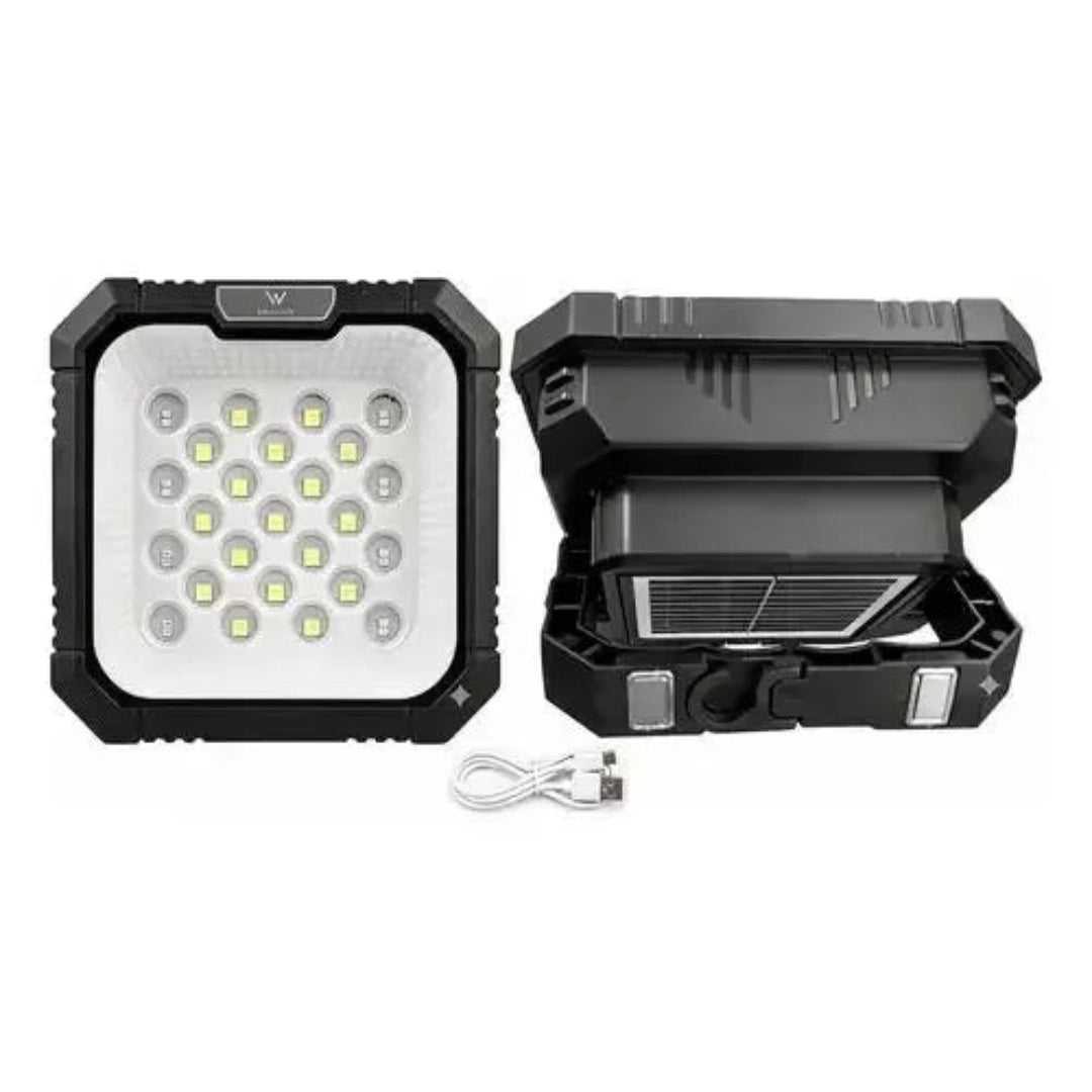 A rugged black solar lantern shown from the front and open side, with a white USB charging cable in front, on a plain white background.
